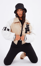 Women's Beige Varsity Bomber Leather Jacket with White Sleeves - Elegant and Trendy